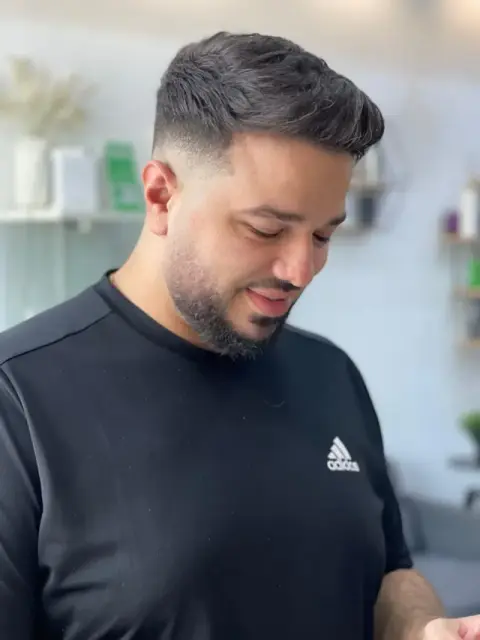Textured quiff with a mid drop fade and a fully blended beard trim at Barberhood barbershop in JVC, Dubai