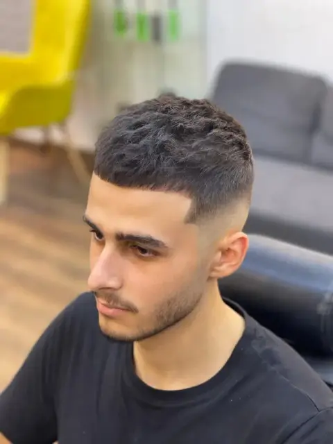 French crop with a straight fringe and a clean mid skin fade, cut at Barberhood barbershop in JVC, Dubai
