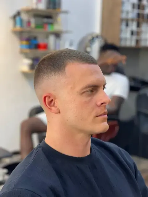 High and tight crew cut with a crisp bald fade, cut at Barberhood barbershop in JVC, Dubai