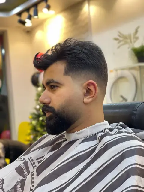 Voluminous brushed-back quiff with a taper fade and full beard sculpt at Barberhood, JVC Dubai